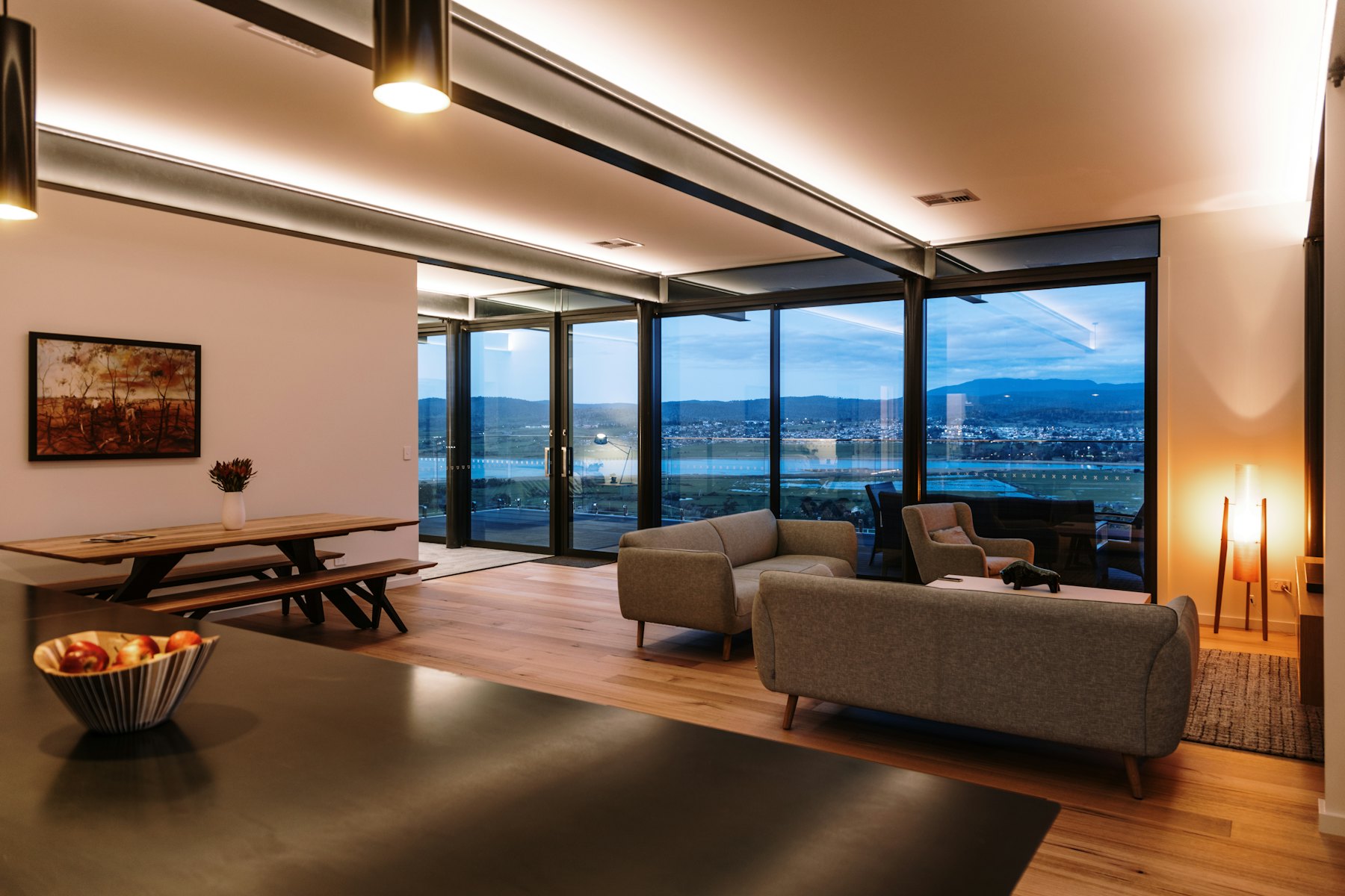 Living room lit by recessed downlights at dusk